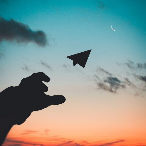silhouette-photo-of-man-throw-paper-plane-1262304